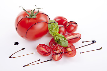 Image showing fresh red tomatoes with balsamic and oilve oil isolated