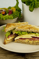 Image showing fresh tasty club sandwich with cheese and ham on table