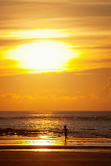 Image showing Sunset on a beach with silhouette of a kid