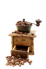 Image showing Old wooden mill with coffee beans.