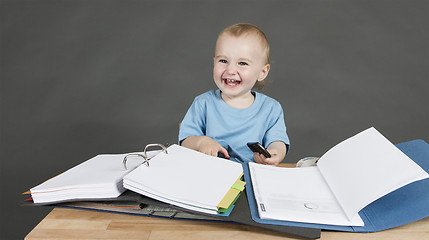 Image showing child with paperwork at desk