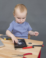 Image showing child working at open hard drive