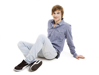 Image showing Young man sitting on the floor