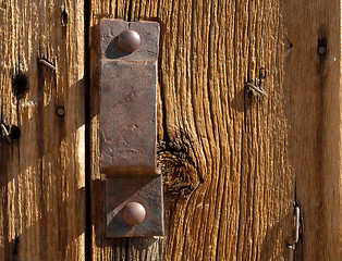 Image showing Antique iron handle on weathered door