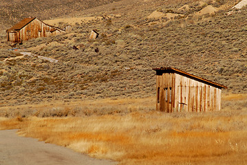 Image showing Two deserted wooden structures in old mining town