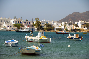 Image showing Greek fishing boats with flag typical white block buildings Poll