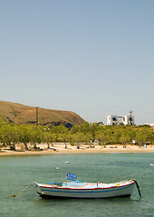 Image showing Greek fishing boat sandy beach with cypress trees Pollonia Milos