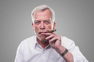 Image showing Handsome senior smoking a cigar