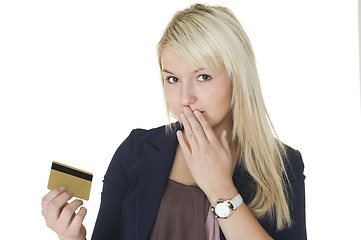 Image showing Woman with guilty look holding credit card