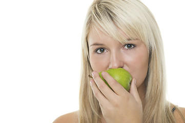 Image showing Woman eating a green pear