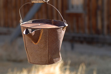 Image showing Rusted pail hanging in deserted gold mining town