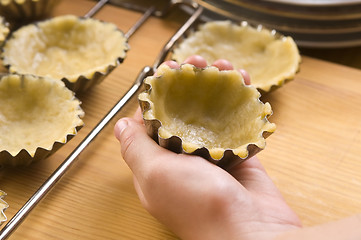 Image showing Detail of child hands making cookies