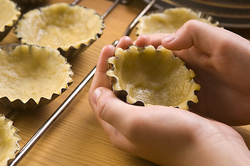 Image showing Detail of child hands making cookies