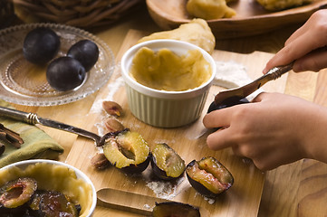 Image showing Detail of child hands making plum tart