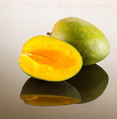 Image showing Two mangoes on reflecting surface