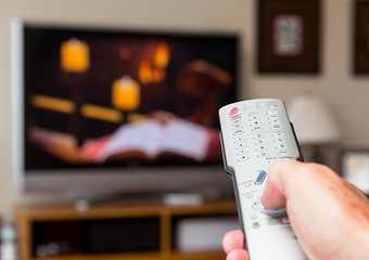 Image showing Close up of TV remote control with television