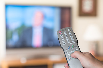 Image showing Close up of TV remote control with television