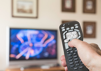 Image showing Close up of TV remote control with television