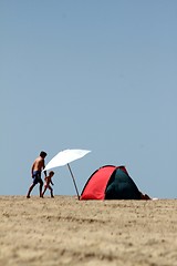 Image showing lonely parasol and sun tent on the beach