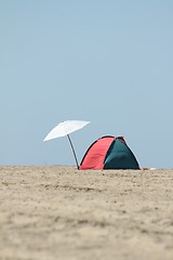 Image showing lonely parasol and sun tent on the beach