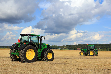 Image showing Two John Deere Tractors on display