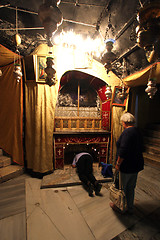 Image showing Women pray at the silver star marks the traditional site of Jesus' birth in a grotto underneath Bethlehem's Church of the Nativity