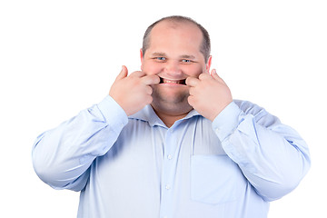 Image showing Fat Man in a Blue Shirt, Contorts Antics