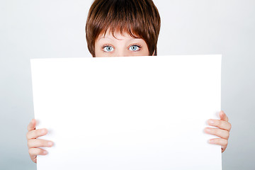 Image showing young girl hiding a banner