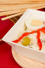 Image showing Russian salad and breadsticks