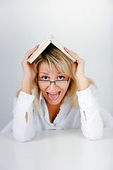 Image showing funny blonde hidden under a book