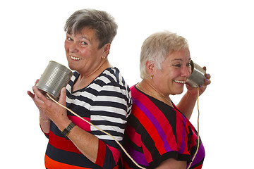 Image showing Female senior talking with can telephone