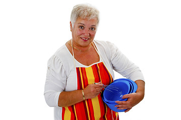 Image showing Female senior housewife with bowls and eggbeater