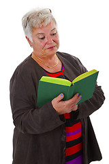 Image showing Female senior reading a book