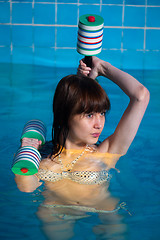 Image showing Pretty girl doing aqua aerobic exercise