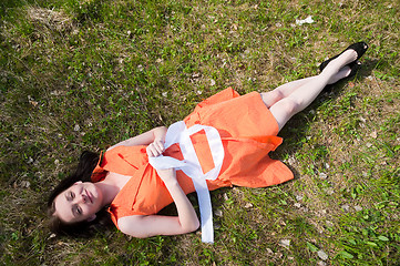 Image showing Pretty girl laying on grass