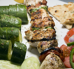 Image showing chicken shish kabob with zucchini  salad Greek style as photogra