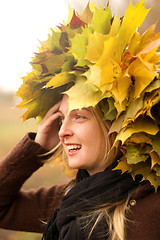 Image showing Woman with autumn wreath outdoors