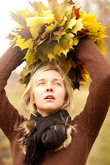Image showing Woman with autumn wreath outdoors