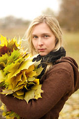 Image showing Woman with autumn wreath outdoors