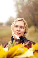 Image showing Woman with autumn wreath outdoors