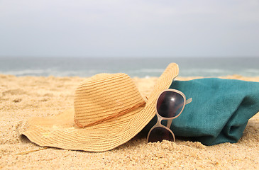 Image showing  Blue beach bag on the seacoast and straw hat 