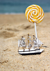 Image showing Small toy sailing ship on the beach 