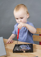 Image showing young child working at open hard drive