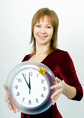 Image showing attractive girl with a clock
