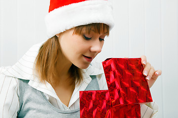 Image showing Attractive girl opens a Christmas present