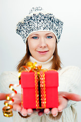 Image showing Attractive girl gives a wrapped gift