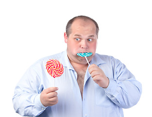 Image showing Fat Man in a Blue Shirt, Eating a Lollipop