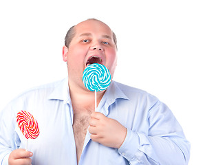 Image showing Fat Man in a Blue Shirt, Eating a Lollipop