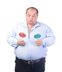 Image showing Fat Man in a Blue Shirt, with Lollipop