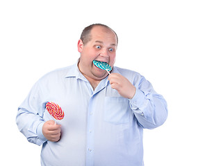 Image showing Fat Man in a Blue Shirt, Eating a Lollipop